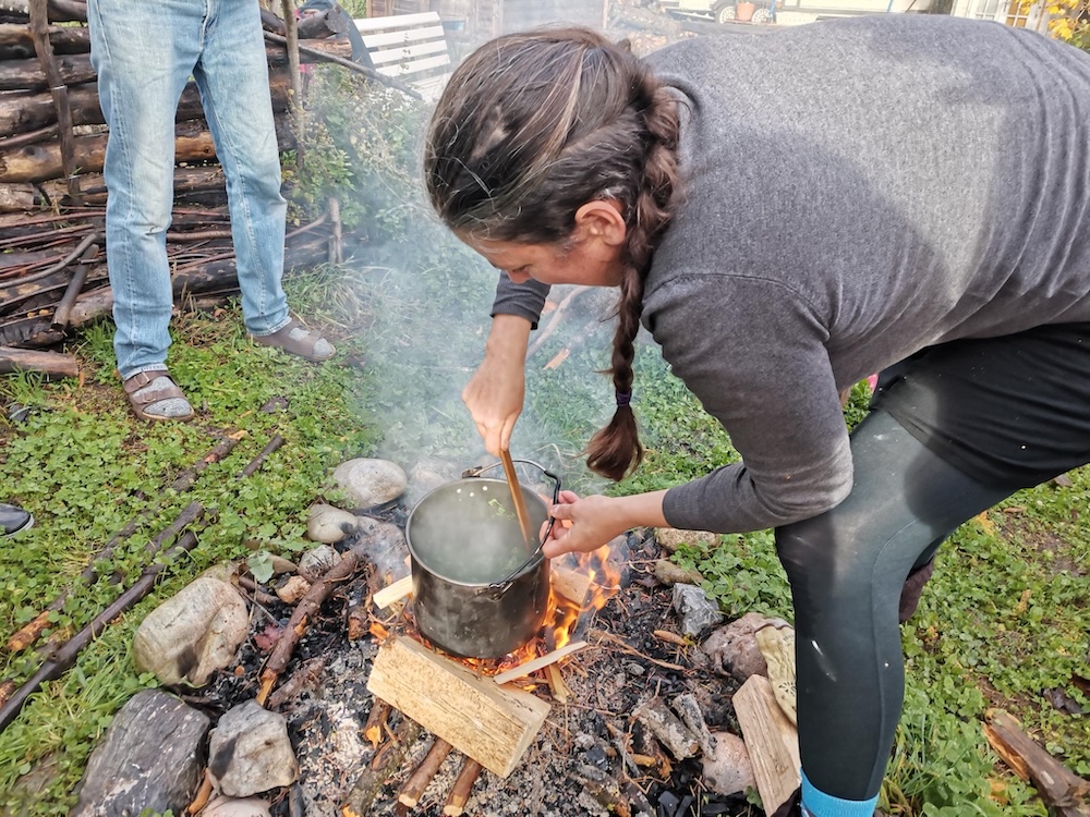Florence prépare une potée sur le feu de bois